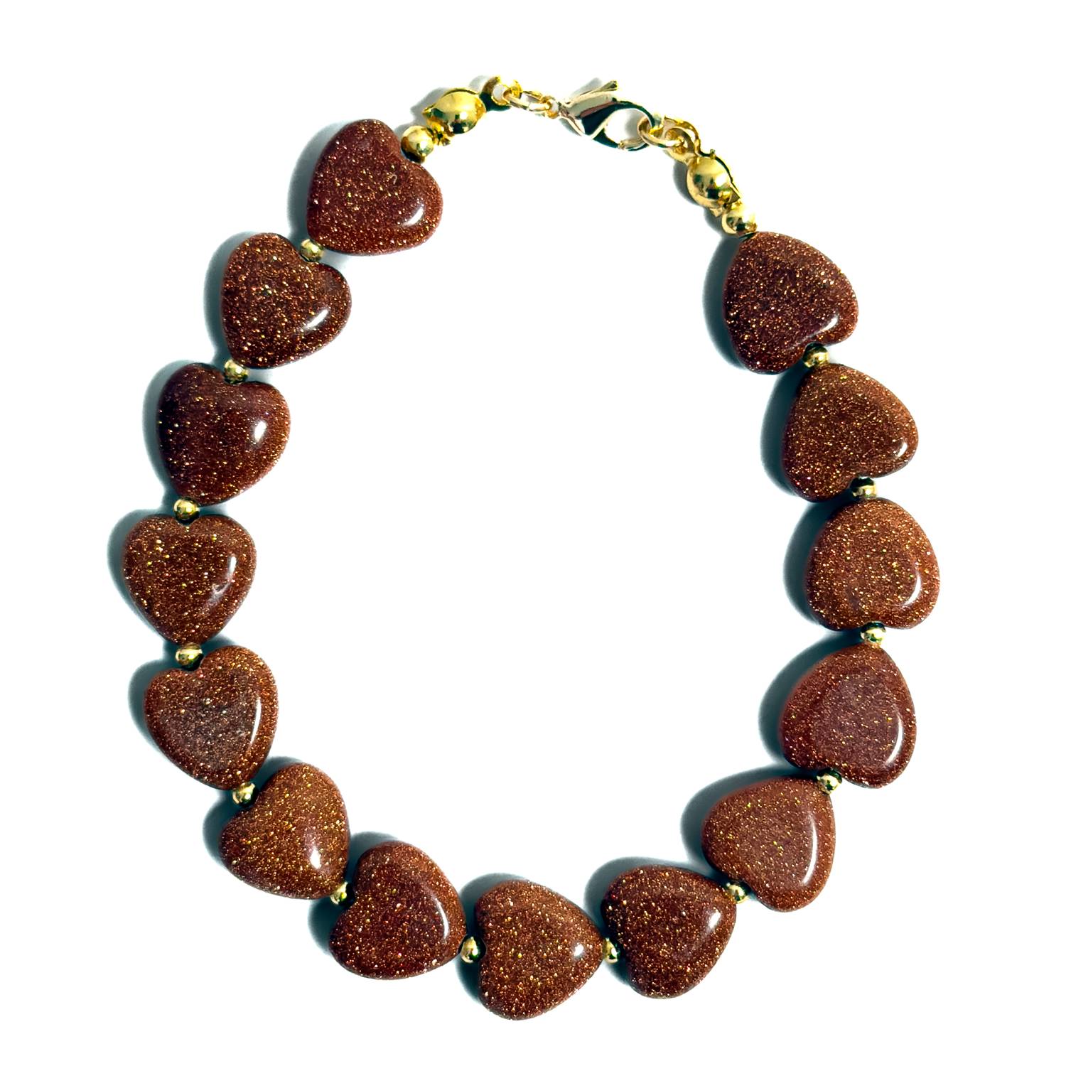 Pulsera artesanal MAVIS elaborada con corazones de Goldstone cobriza de acabado brillante y destellos dorados, con separadores dorados y broche de acero inoxidable.